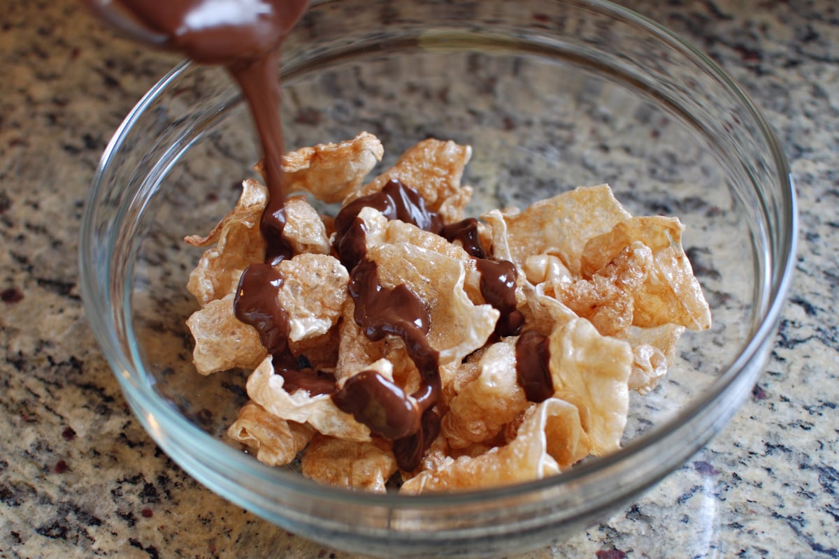 pour on the chocolate for the Muddy Buddy pork rinds