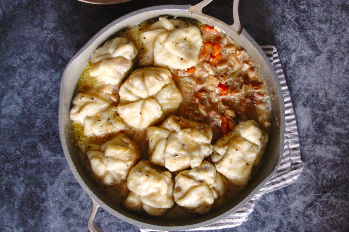 the pork buns steam on top of the chicken stew