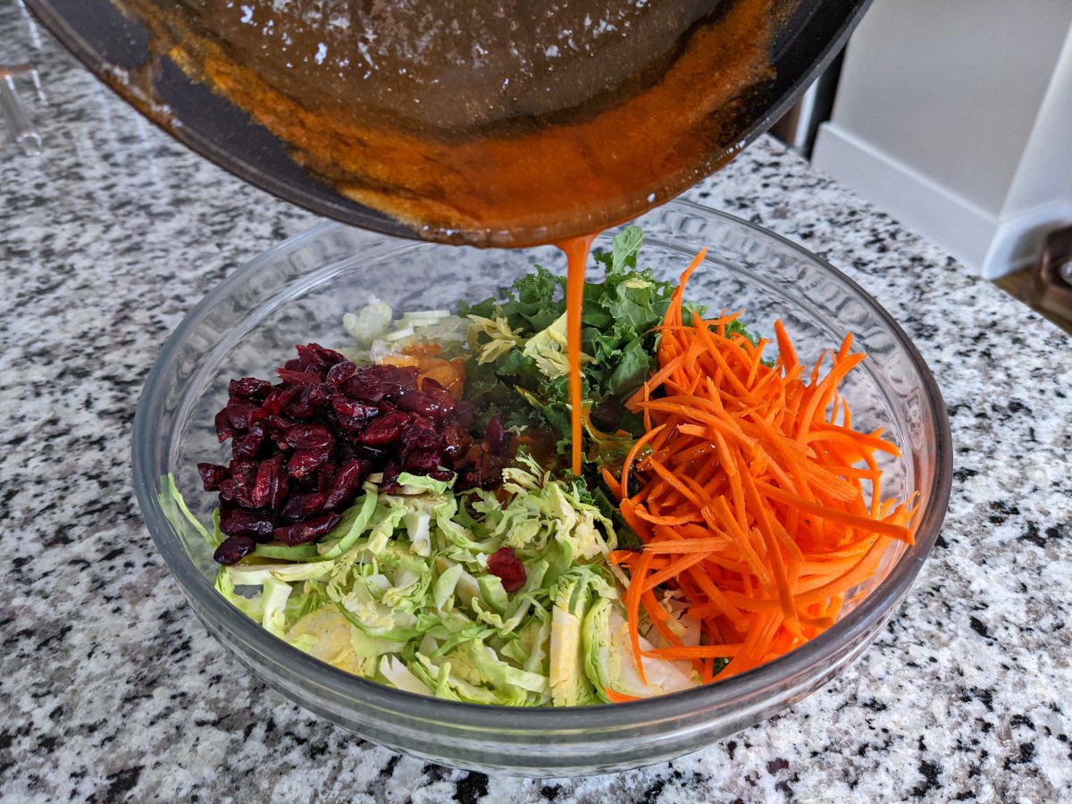 Pouring the dressing onto the veggies