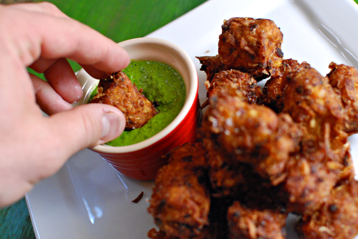 vindaloo tater tots dipping in the cilantro sauce